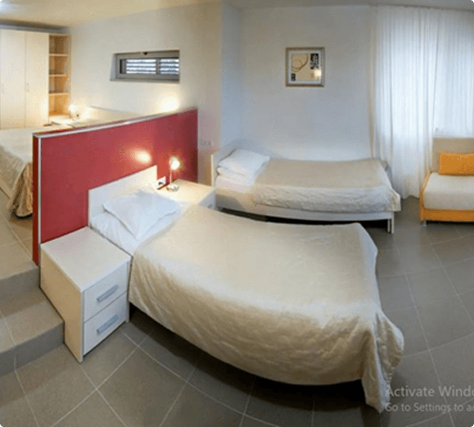 Family hotel room with several beds